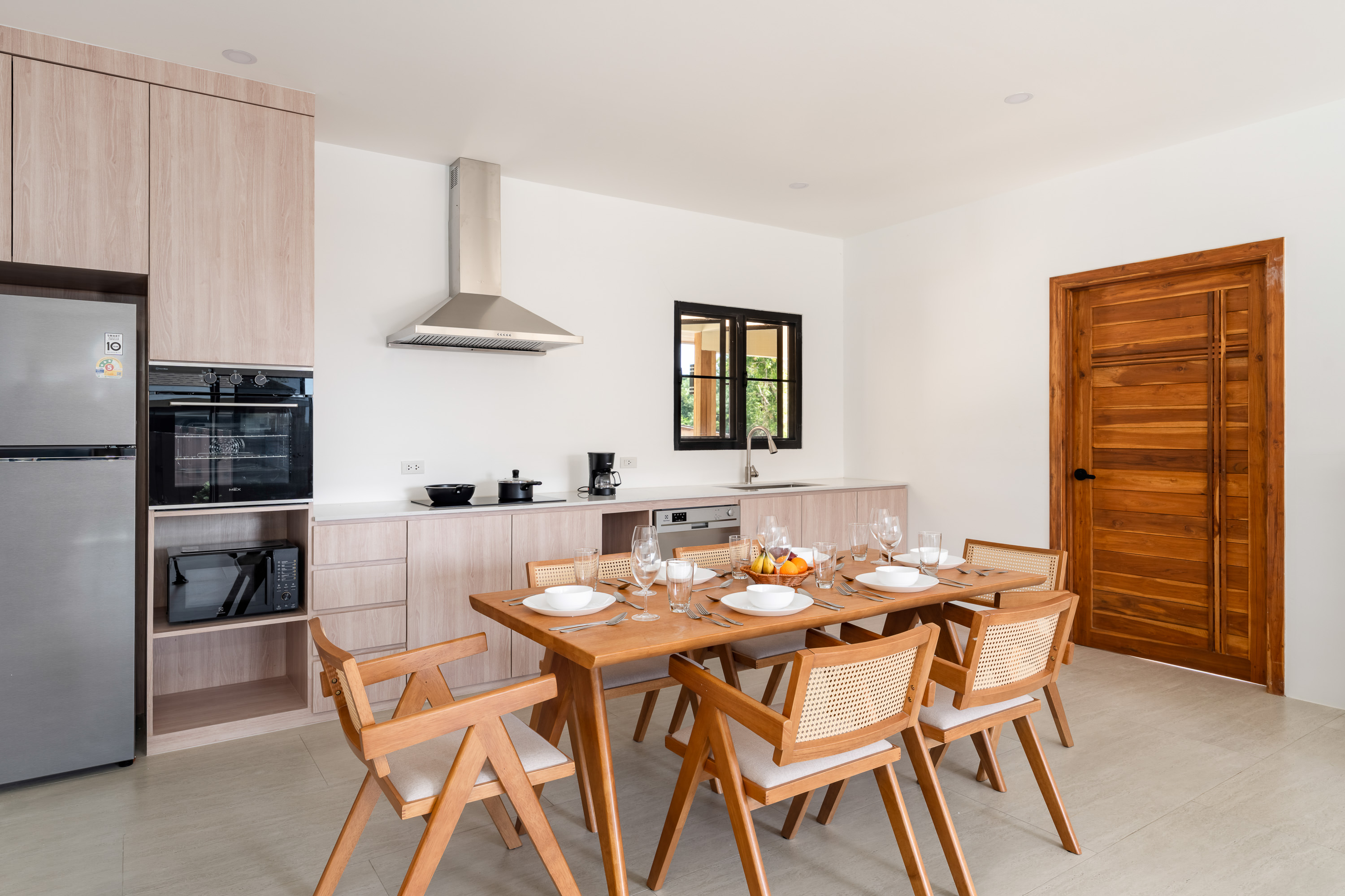 Open luminous living space with floor-to-ceiling glass in N27 The Light Villa